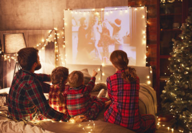 family mother father and children watching projector, film, movi