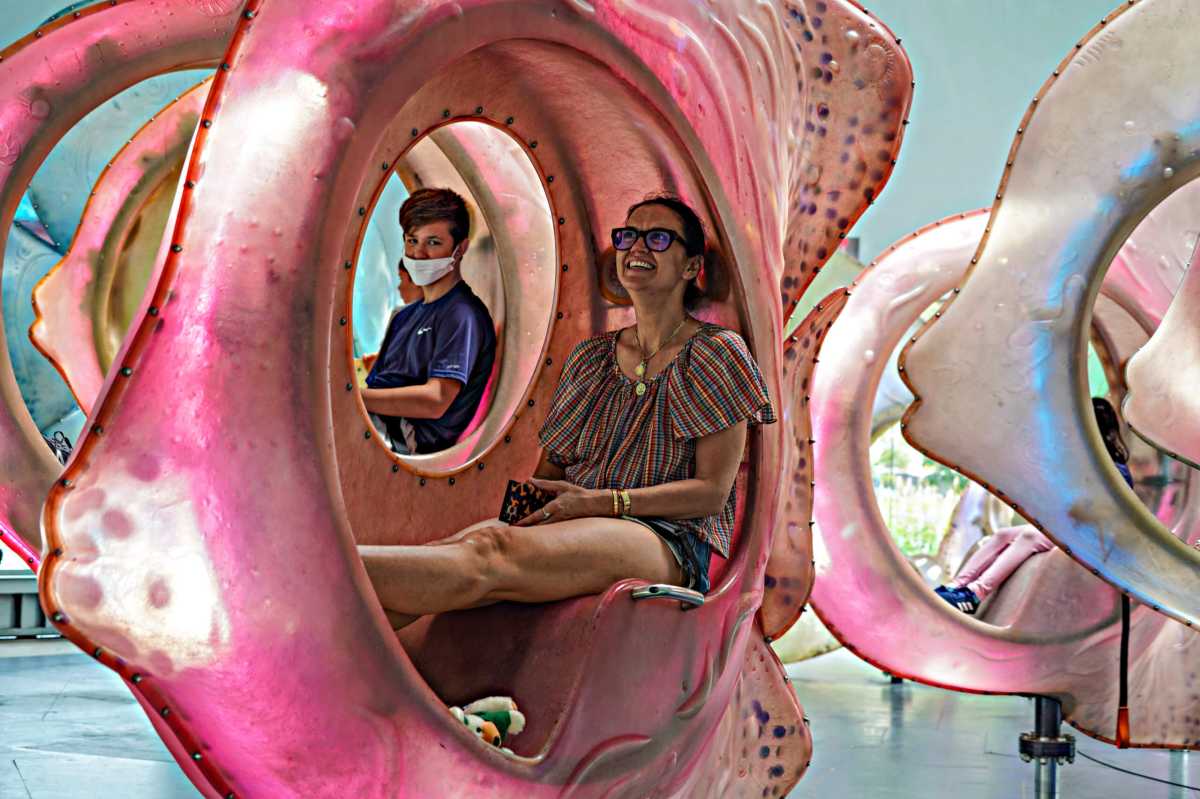 A family rides gigantic fish at the Seaglass in Battery Park on July 8.