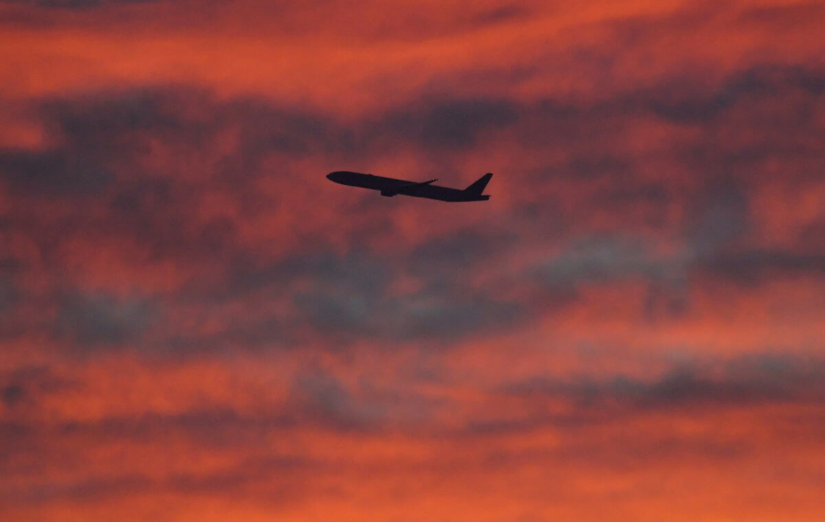 FILE PHOTO: A plane is seen shortly after take-off at sunset, from Heathrow Airport, London