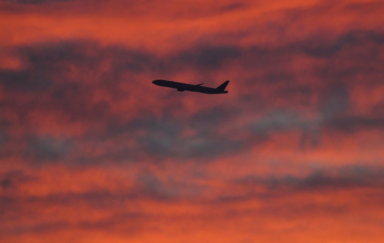 FILE PHOTO: A plane is seen shortly after take-off at sunset, from Heathrow Airport, London
