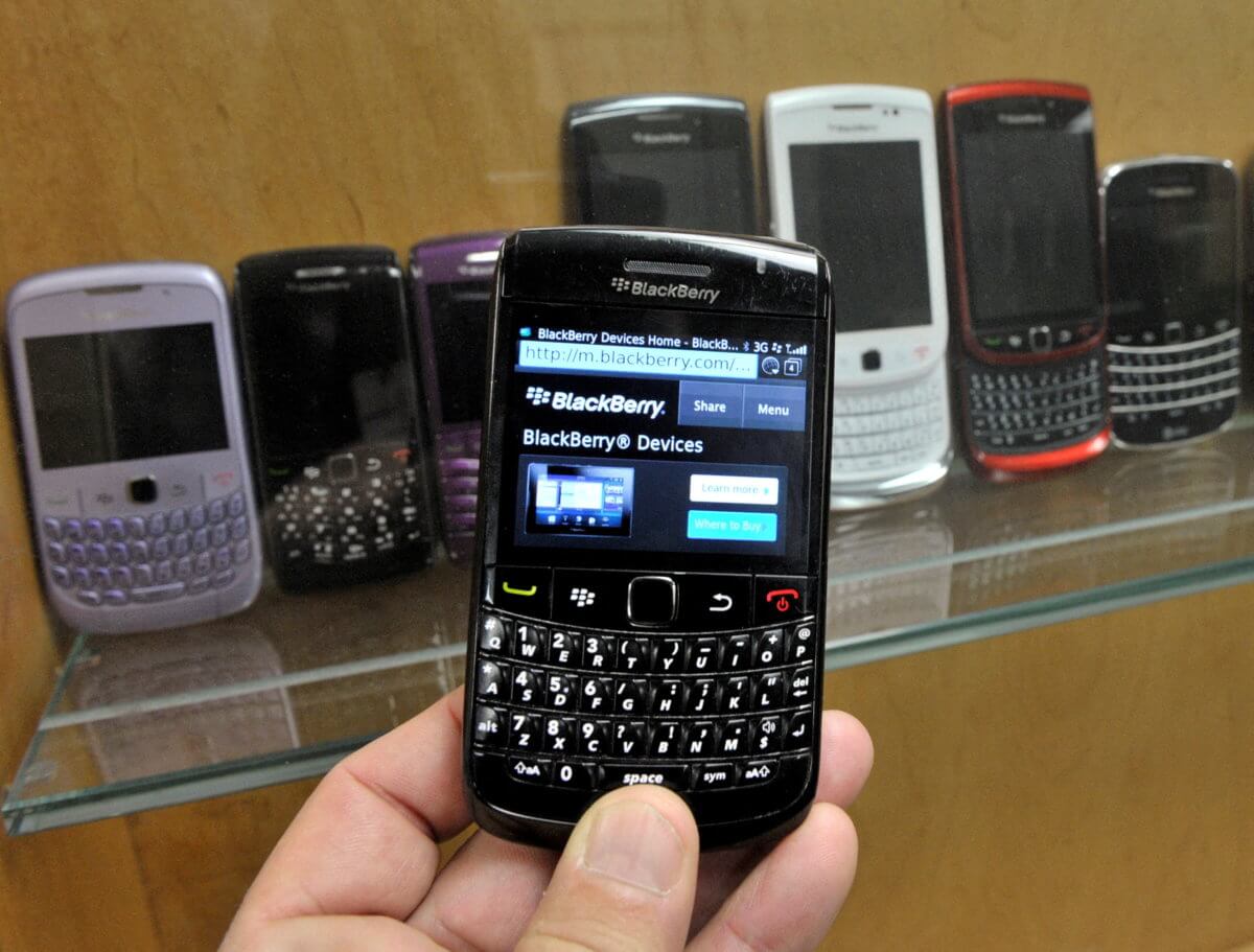 FILE PHOTO: A BlackBerry device is shown in front of products displayed in a glass cabinet at the Research in Motion offices in Waterloo