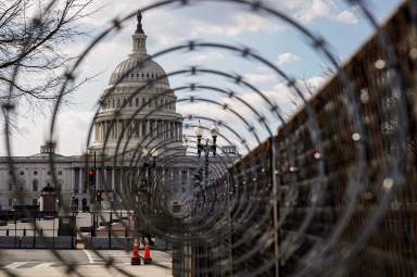 FILE PHOTO: The U.S. Capitol is seen through razor wire in Washington