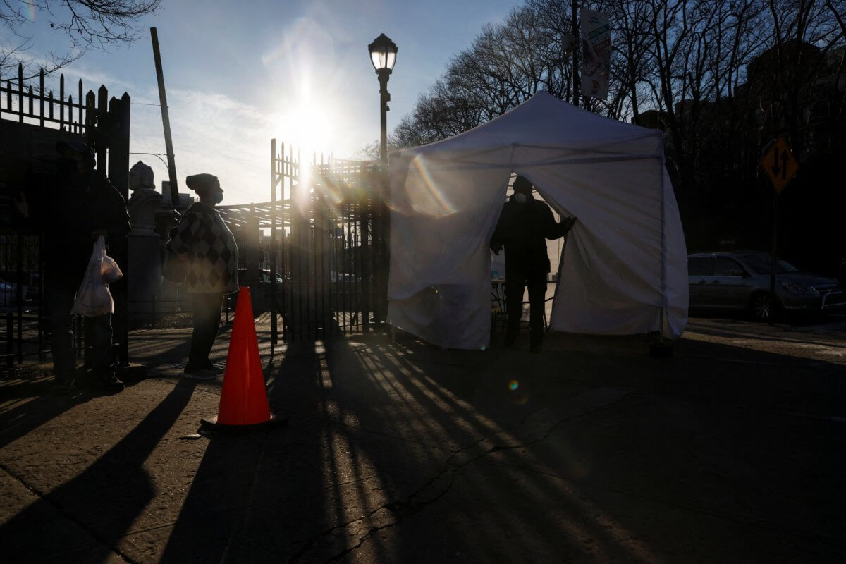 People wait in line to a COVID-19 pop-up testing site in the Bronx borough of New York City