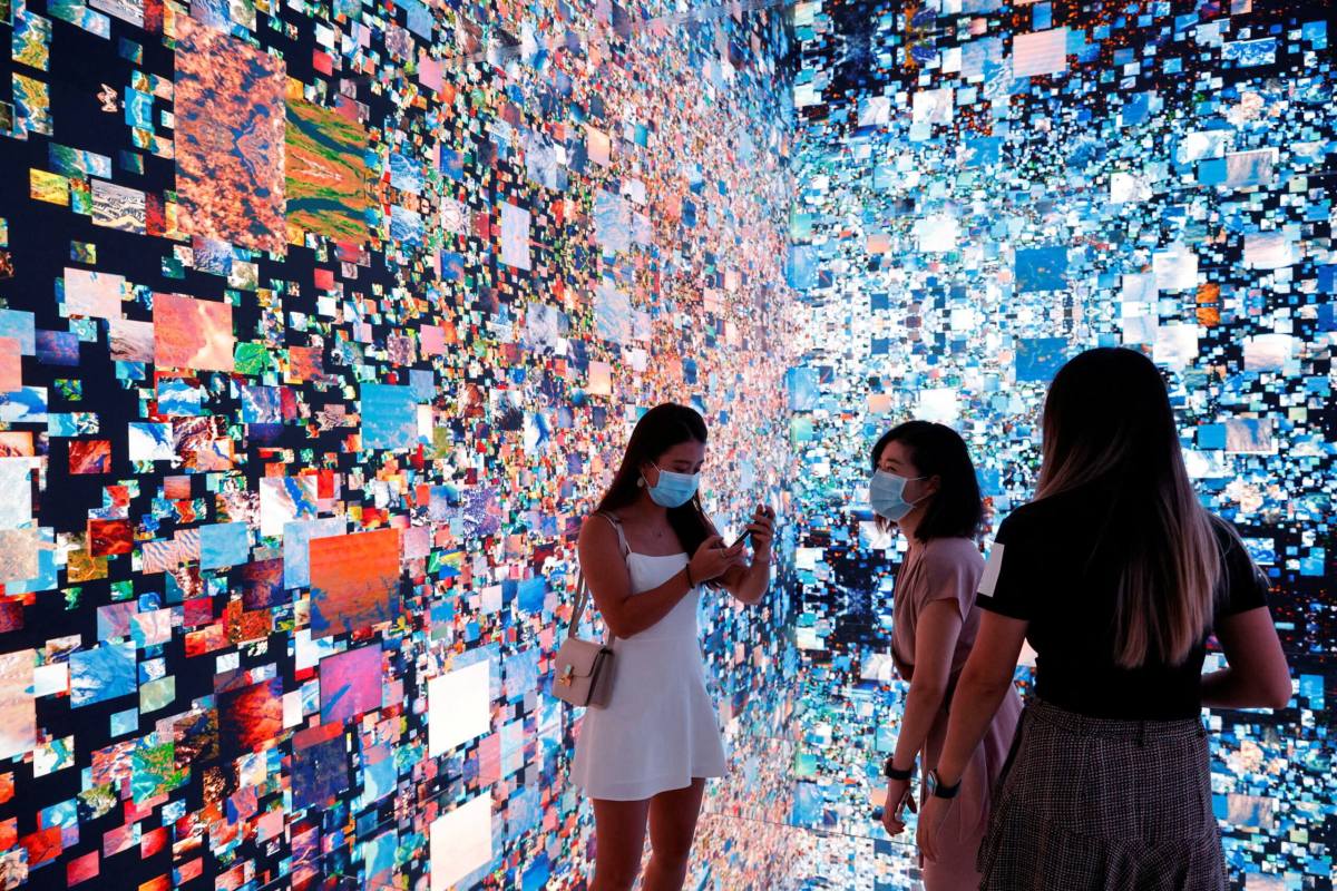 FILE PHOTO: Visitors are pictured in front of an art installation which will be converted into NFT and auctioned online at Sotheby’s, in Hong Kong