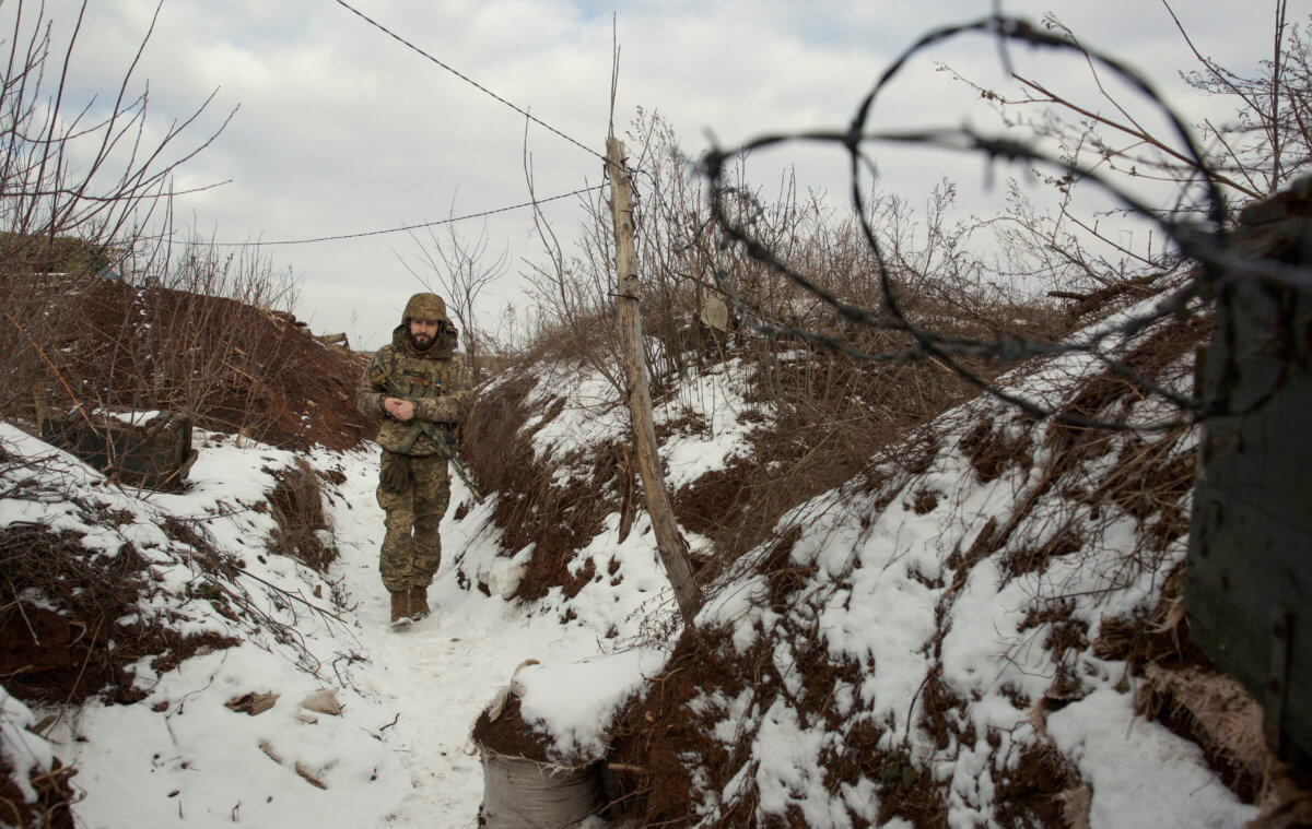 FILE PHOTO: A service member of the Ukrainian armed forces walks at combat positions in the Donetsk region