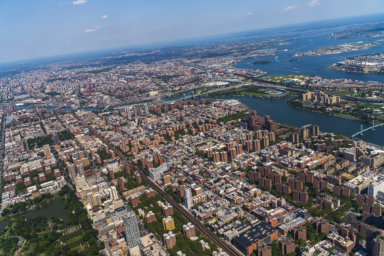 Aerial view of Central Park, Manhattan, and Harlem, and The Bronx in a distance behind, from a helicopter on a sunny summer day.