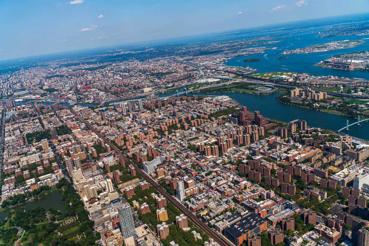 Aerial view of Central Park, Manhattan, and Harlem, and The Bronx in a distance behind, from a helicopter on a sunny summer day.