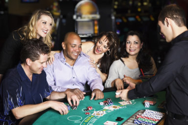 Diverse Group of People Playing Blackjack In a Casino
