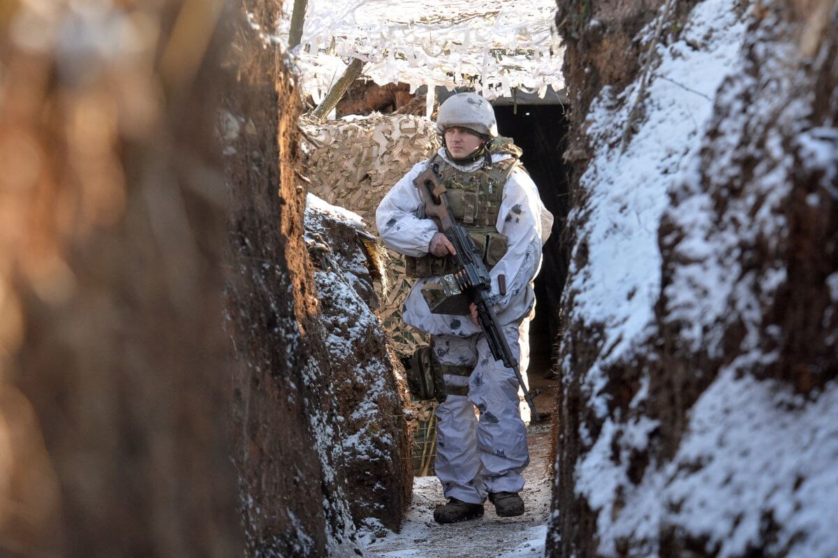 FILE PHOTO: Ukrainian service members guard the area near the line of separation in the Donetsk region
