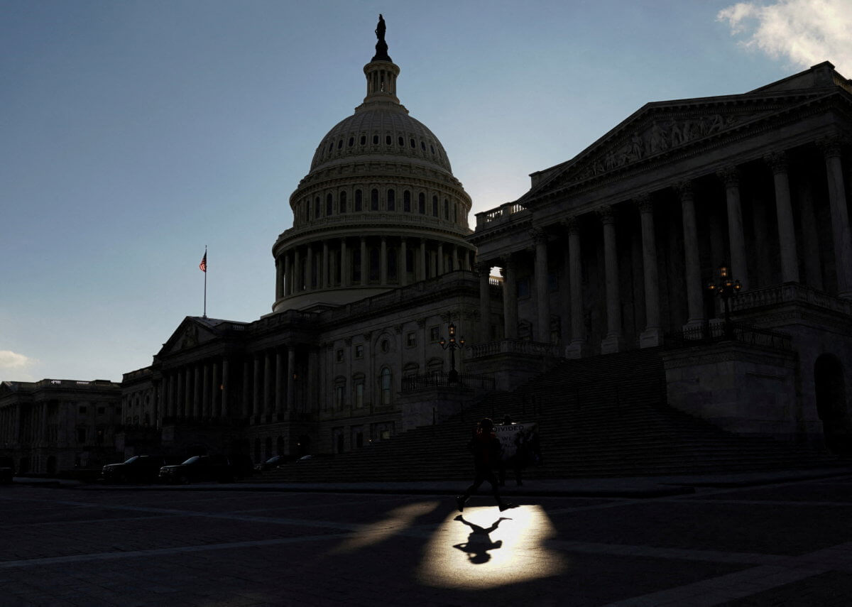 FILE PHOTO: A jogger passes the by the U.S Capitol in Washington