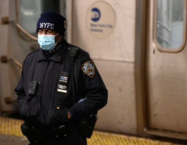 A transit police officer guards a shooting scene at Broadway Junction.