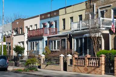 A Row of Beautiful Old Homes along the Sidewalk in Astoria Queens New York