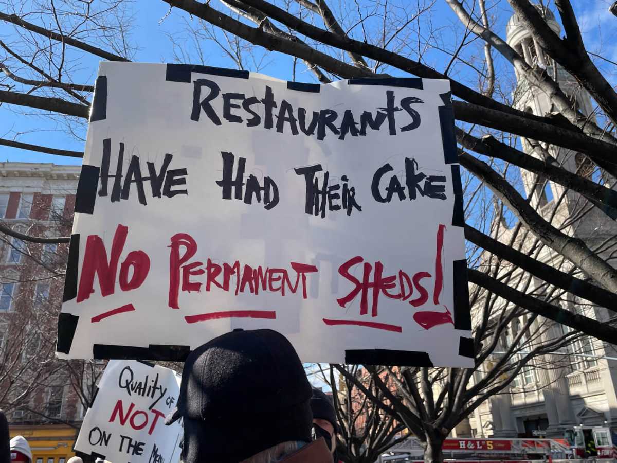 Father Demo Sq. protest sign.