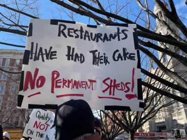 Father Demo Sq. protest sign.
