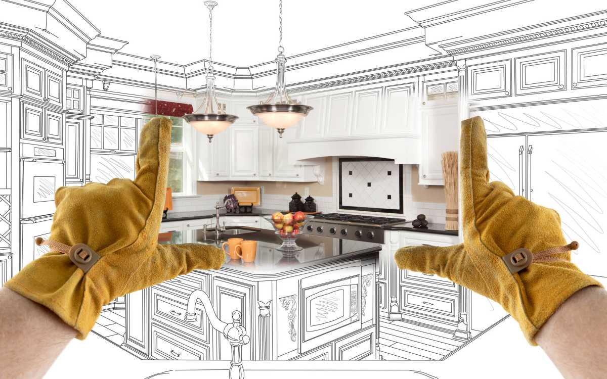 Male Contractor Hands Framing Completed Section of Custom Kitchen Design Drawing