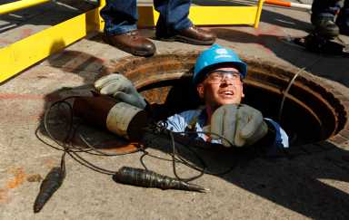 A Con Edison worker attempts to locate the source of a power outage in New York