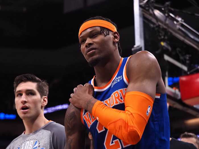 Cam Reddish holds his shoulder after suffering an injury against the Sacramento Kings on March 7.