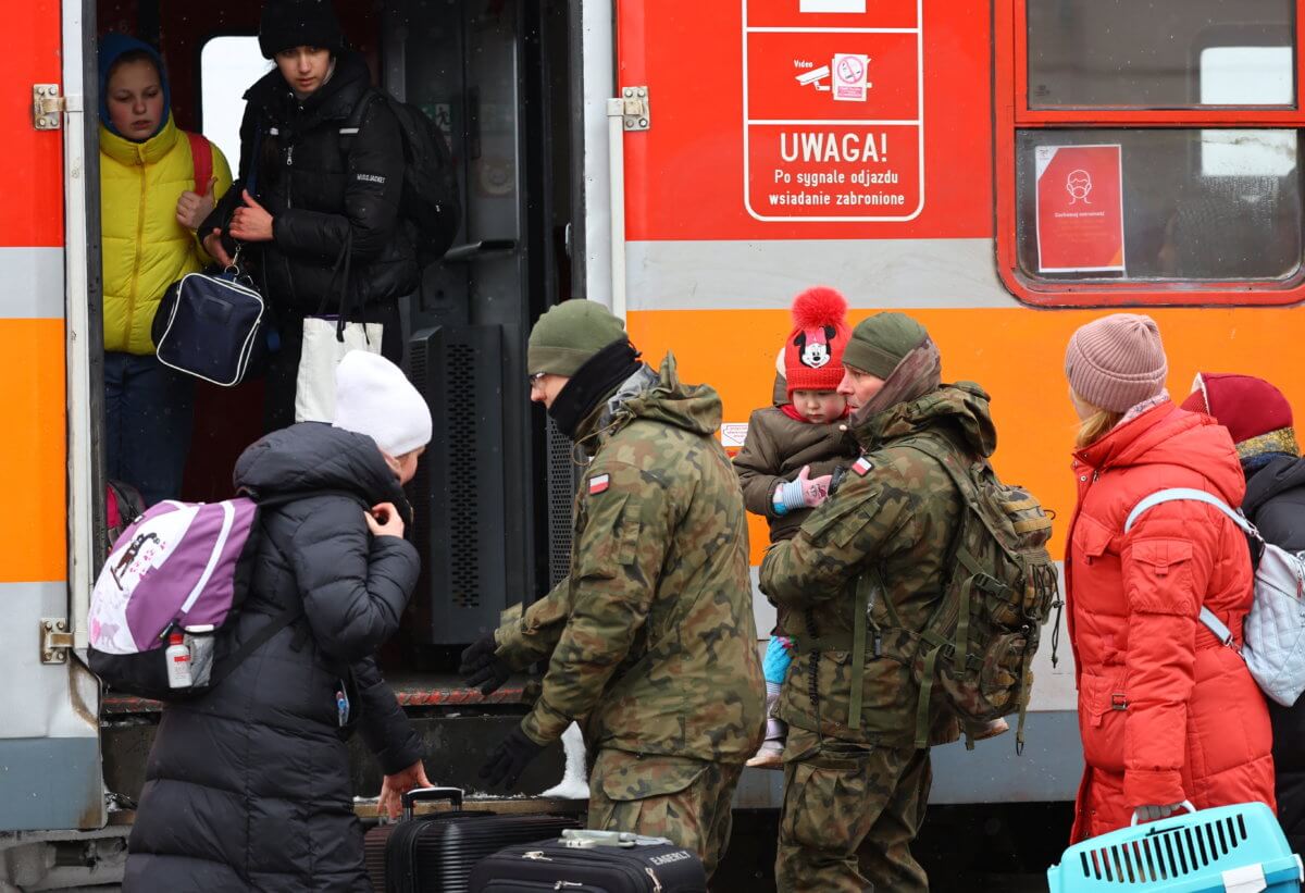 People fleeing Russia’s invasion of Ukraine arrive at the border checkpoint in Medyka