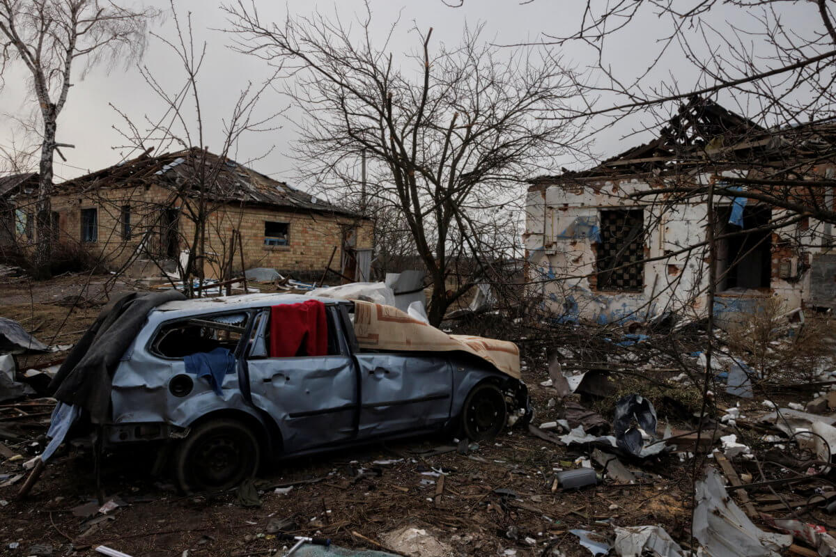 The debris of damaged houses lies on the ground near the spot where a cultural center and administration building once stood, destroyed during an aerial bombing, in the village of Byshiv outside Kyiv