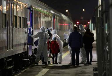 A person is transported from a sanitary train that carried children with oncological diseases who fled Russia’s invasion of Ukraine, in Kielce