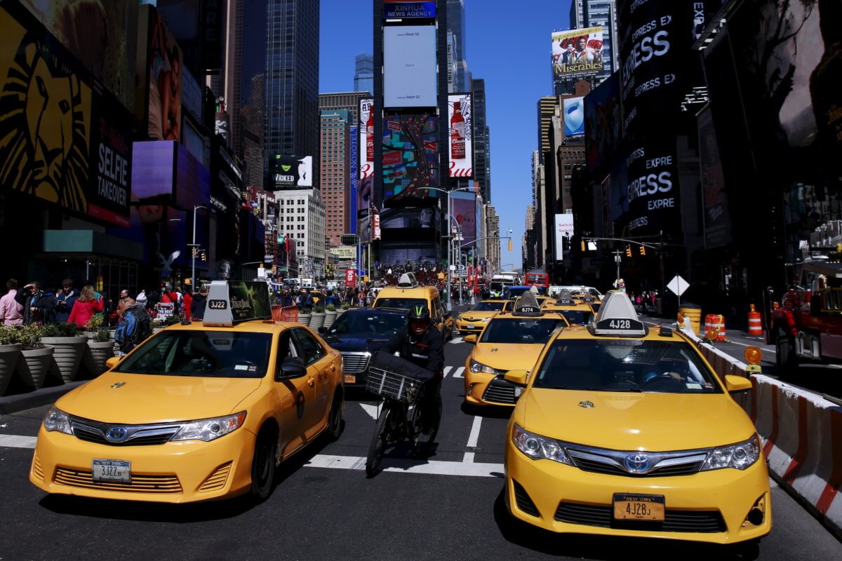 FILE PHOTO: New York City taxi cabs drive through Times Square in New York