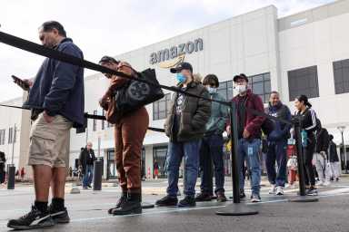 Workers stand in line to cast ballots for a union election at Amazon’s JFK8 distribution center, in Staten Island, New York City