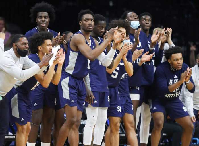 The Saint Peter's bench reacts in the first half against Purdue.