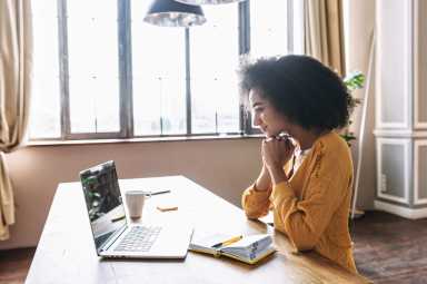 A young woman using laptop for video call