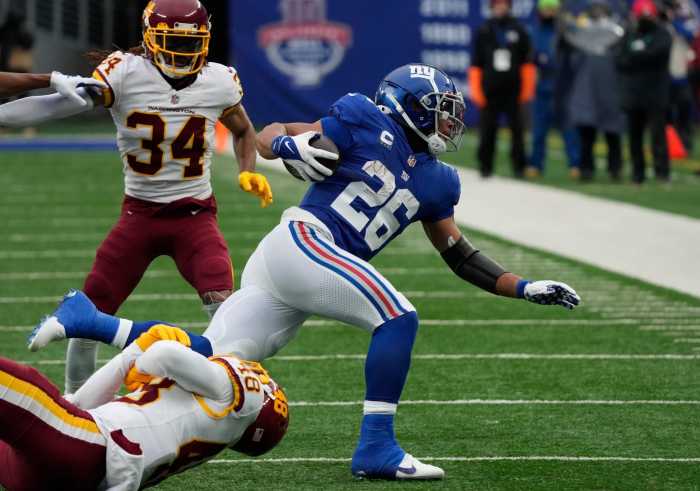Giants running back Saquon Barkley is tackled against the Washington Football Team.