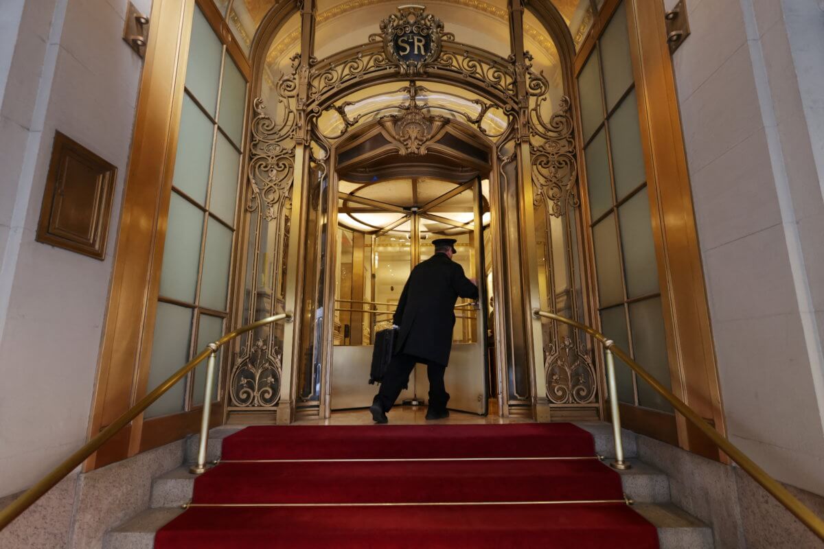 A doorman enters the St. Regis hotel in Manhattan, New York City