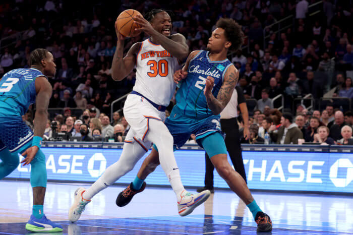Knicks forward Julius Randle drives to the basket against Charlotte Hornets forward P.J. Washington.