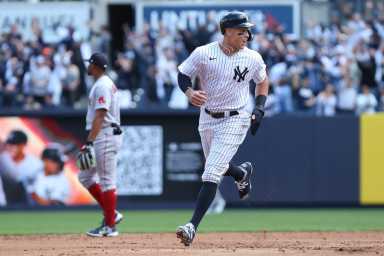 Yankees right fielder Aaron Judge reacts to a home run by New York Yankees first baseman Anthony Rizzo against Boston Red Sox .