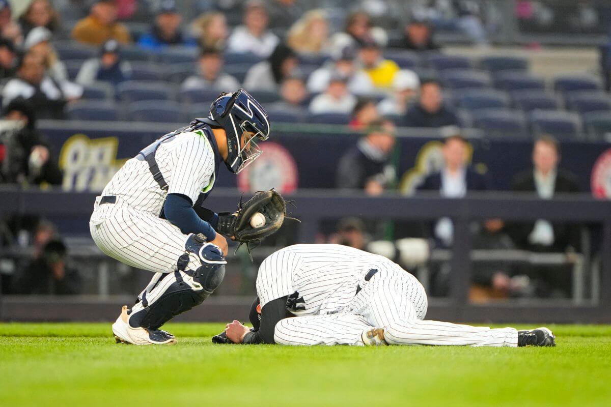 Yankees pitcher Jordan Montgomery goes down after being hit by a line drive by Boston Red Sox shortstop Xander Bogaerts.
