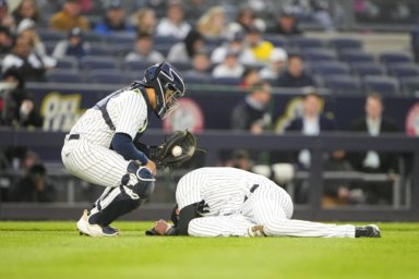 Yankees pitcher Jordan Montgomery goes down after being hit by a line drive by Boston Red Sox shortstop Xander Bogaerts.