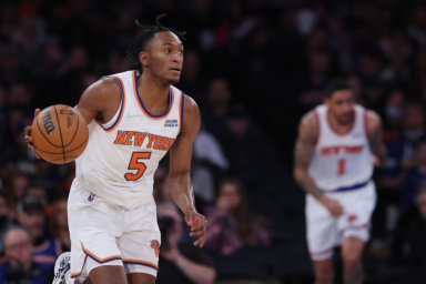 Knicks guard Immanuel Quickley dribbles up court during the second half against the Toronto Raptors, while Obi Toppin trails.