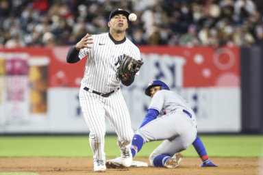 Yankees second baseman Gleyber Torres is unable to hold onto the ball, allowing Toronto Blue Jays second baseman Santiago Espinal to steal second base in the fifth inning.