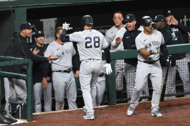Yankees third baseman Josh Donaldson celebrates with teammates following his fifth inning two run home run against the Baltimore Orioles