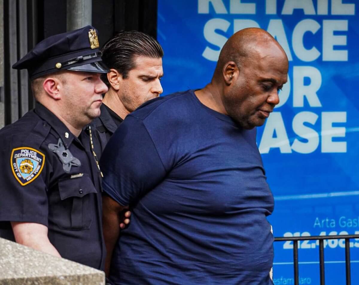 Cops lead Frank James out of the 9th Precinct in Manhattan on April 13.