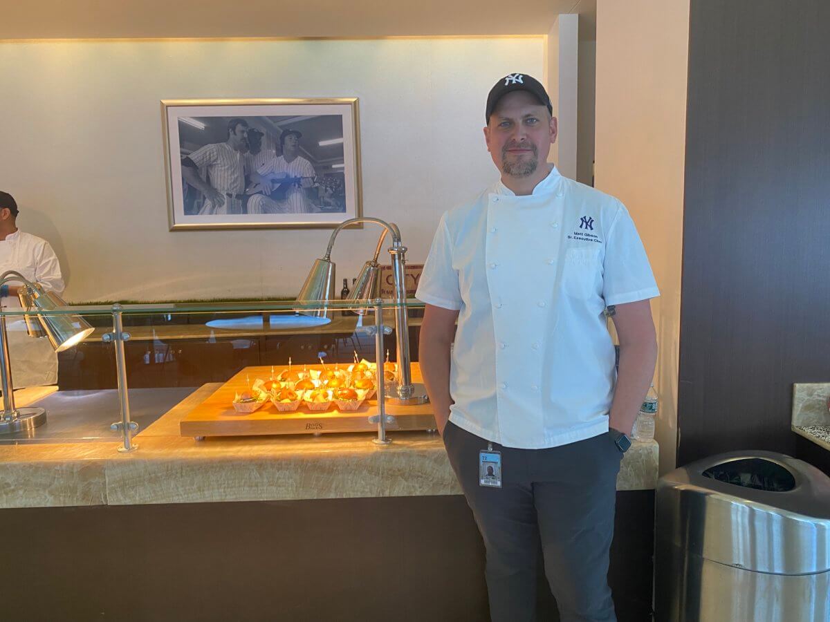 Senior Executive Chef Matt Gibson poses before some of Yankee Stadium’s new food options.