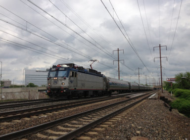 2014-05-15_15_01_21_Amtrak_train_heading_south_along_the_Northeast_Corridor_rail_line_in_Trenton,_New_Jersey