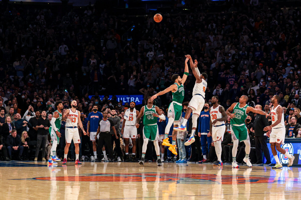 Knicks guard RJ Barrett makes a game-winning 3 point basket during the 4th quarter as Boston Celtics forward Jayson Tatum defends on Jan. 6, 2022.