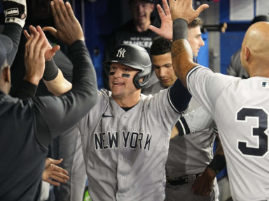 Yankees third baseman Josh Donaldson gets congratulated after scoring against the Toronto Blue Jays.