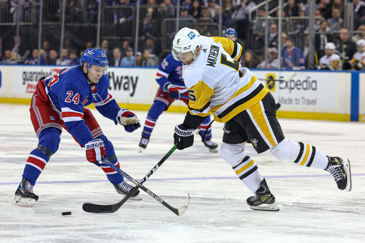 Penguins defenseman Mike Matheson plays the puck against New York Rangers right wing Kaapo Kakko in Game 1.