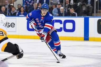 Rangers center Andrew Copp skates across center ice against the Pittsburgh Penguins.