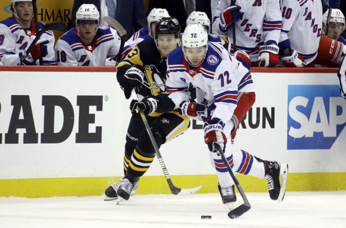 Rangers center Filip Chytil moves the puck against Pittsburgh Penguins left wing Danton Heinen during the loss on Saturday.