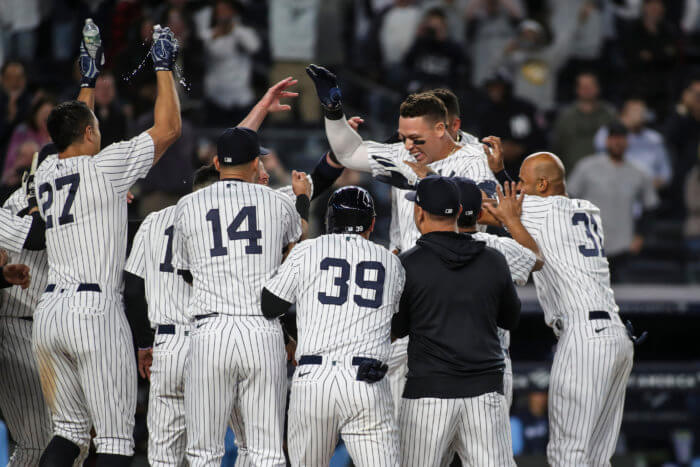 Yankees center fielder Aaron Judge is greeted by his teammates after hitting a walk-off 3-run home run to defeat the Toronto Blue Jays 6-5 on Tuesday.