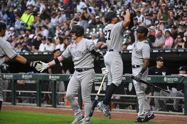 Yankees designated hitter Giancarlo Stanton celebrates with center fielder Aaron Hicks after hitting a 2-run home run.