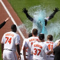 Orioles outfielder Anthony Santander is showered by teammates following his game winning home run in the 9th inning against the Yankees.