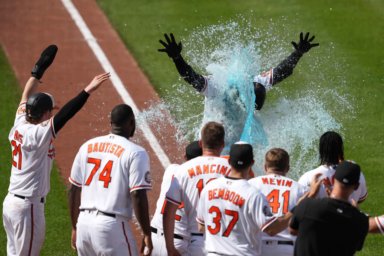 Orioles outfielder Anthony Santander is showered by teammates following his game winning home run in the 9th inning against the Yankees.