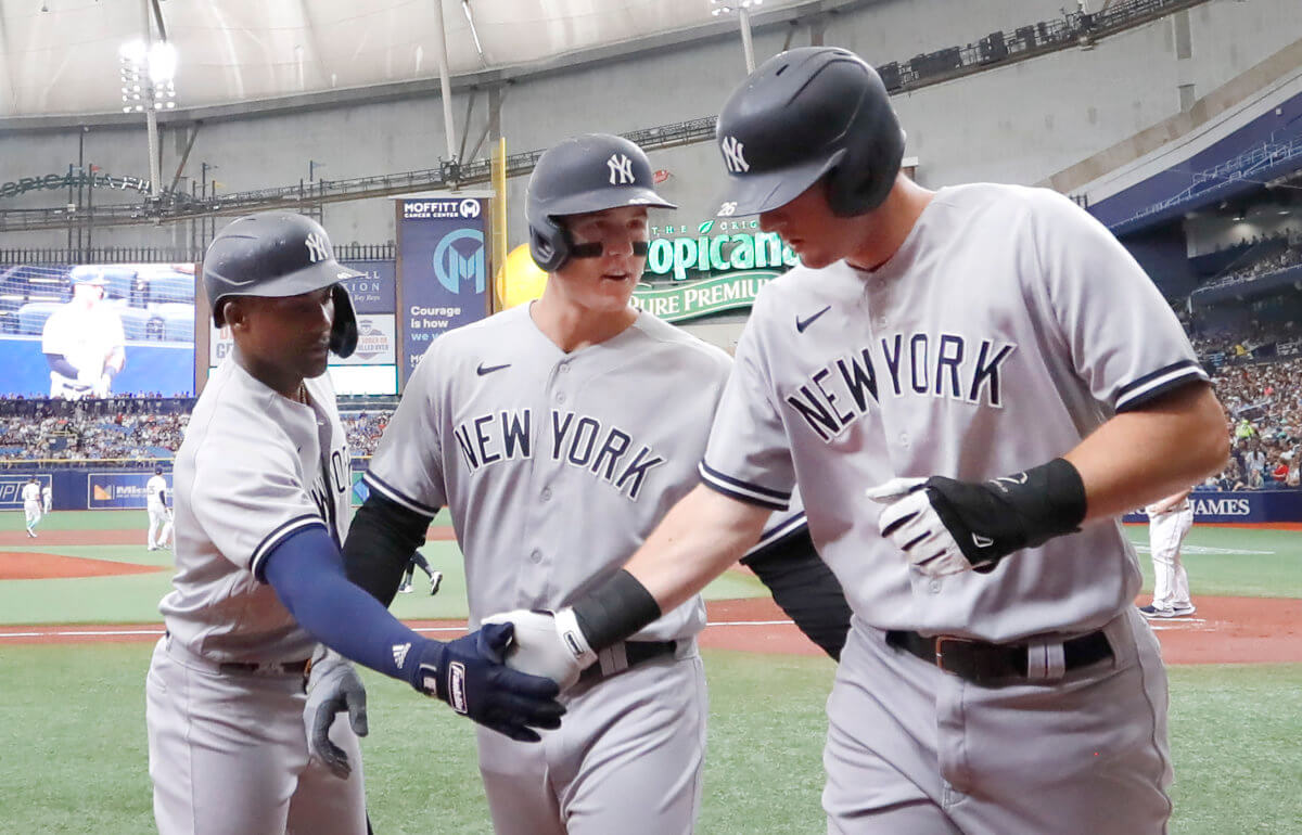 Yankees second baseman DJ LeMahieu, right, is congratulated on scoring by 1st baseman Anthony Rizzo and 2nd baseman Gleyber Torres, left.